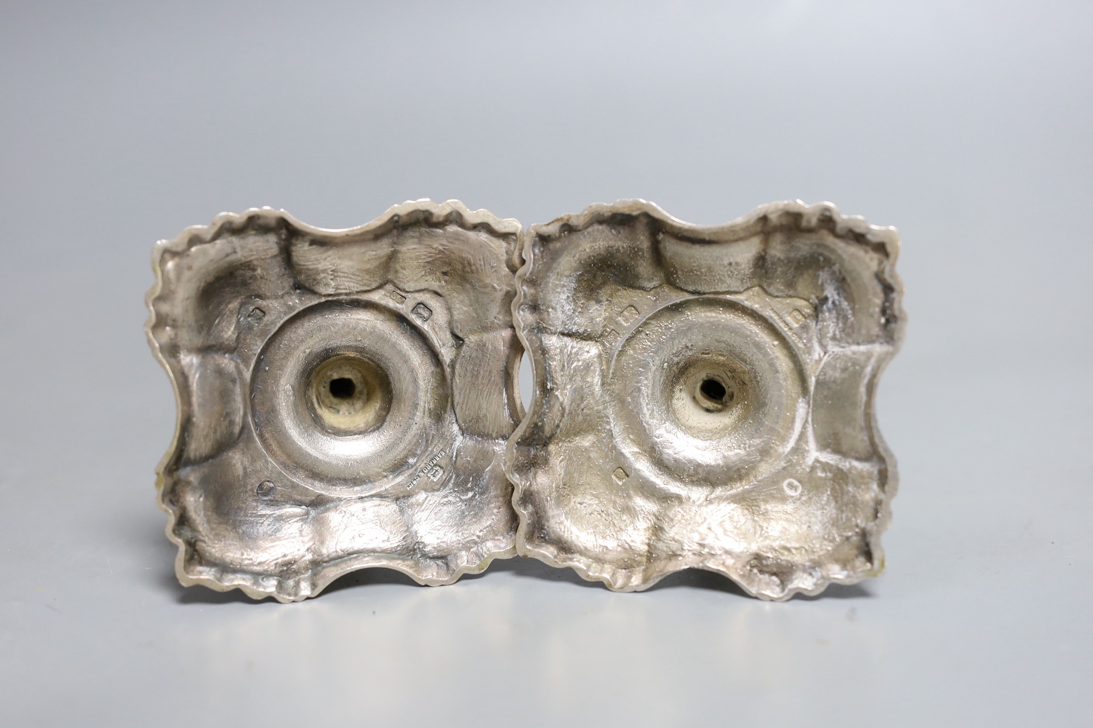 A pair of George V silver taper sticks, by Garrard & Co Ltd, London, 1934, 12.1cm, 10.7oz.
